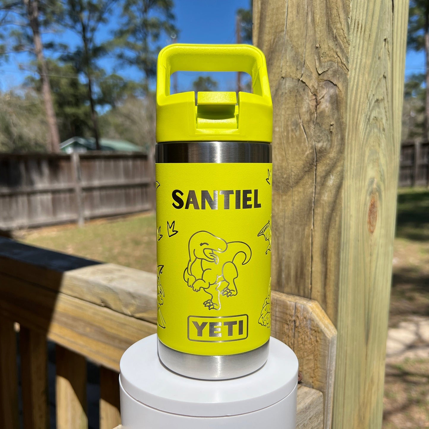 Personalized Kids Yeti 12 oz Water Bottle 12 Design Options - Pine LaserworksYellow YETI bottle with 'Santiel' branding on a wooden surface outdoors.