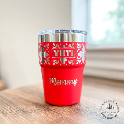 Red YETI tumbler with 'Mommy' on a wooden surface