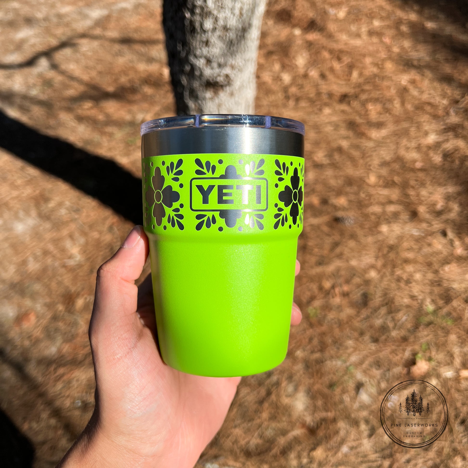 Venom Green YETI tumbler with a Talavera pattern against a natural background.