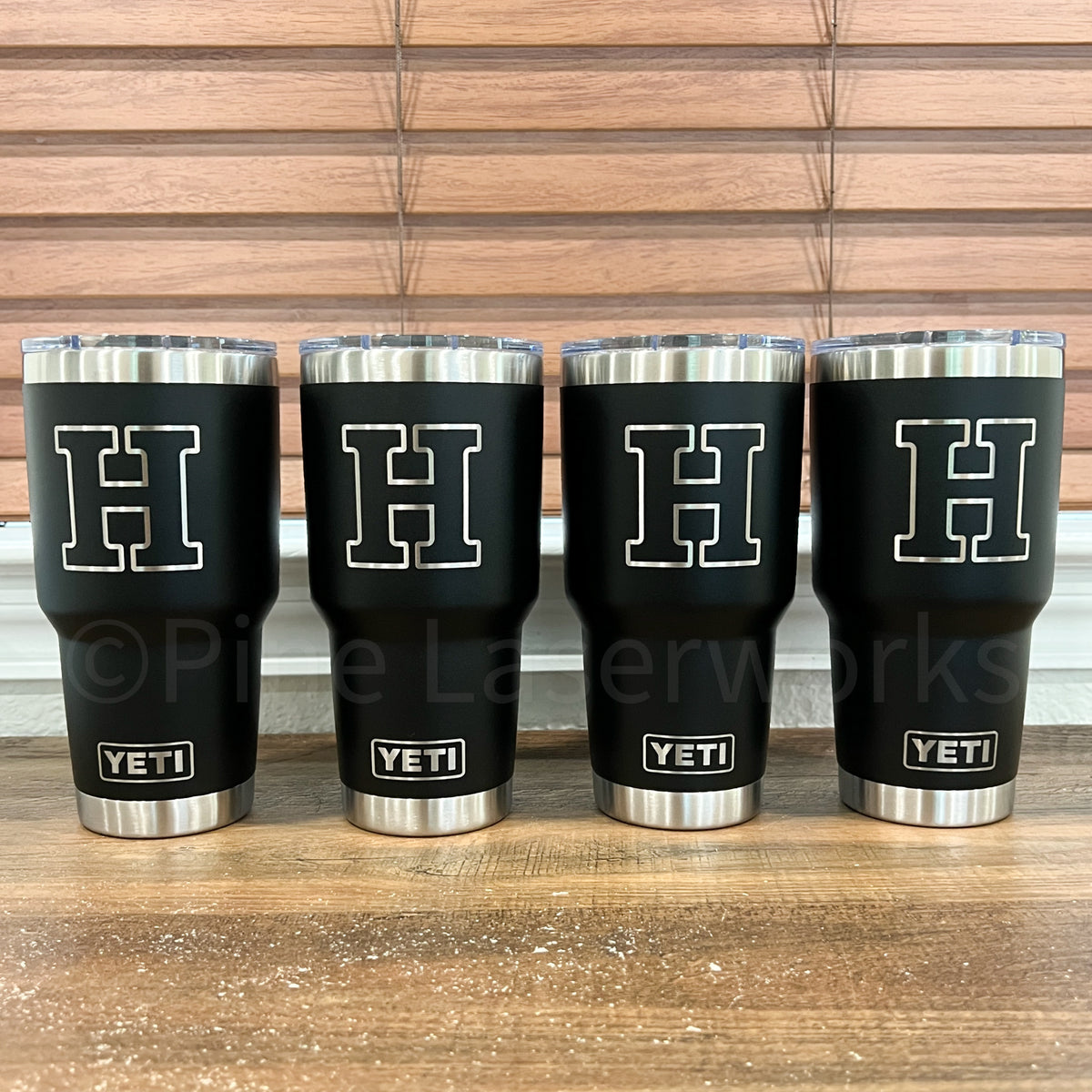 Four black YETI 30oz Tumblers engraved with a large white letter 'H'