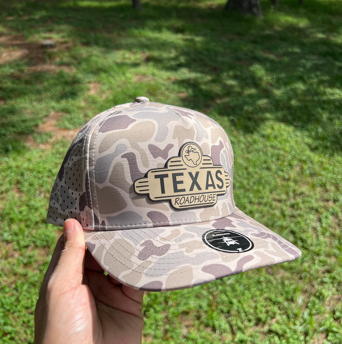 Camouflage Zapped Blackhawk cap with a 'Texas Roadhouse' leatherette patch