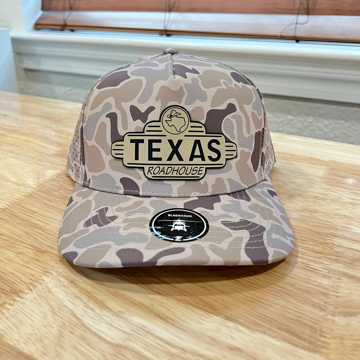 Gray and brown camo Zapped Blackhawk cap with a 'TEXAS ROADHOUSE' patch