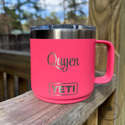 Pink YETI mug with 'Quyen' text on a wooden surface outdoors