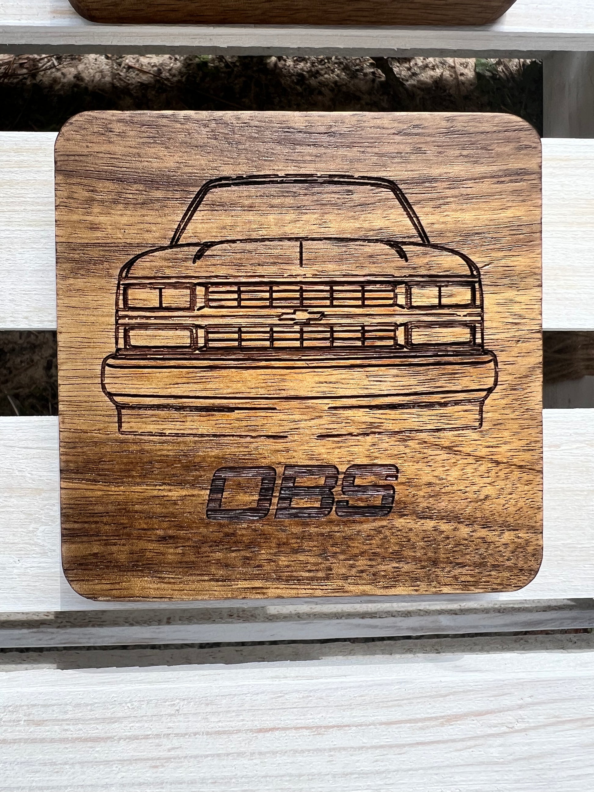 Acacia wood square shape coasters with 88 to 98 Chevy truck front end outline and OBS letters below. Rustic Look and great satin finish.