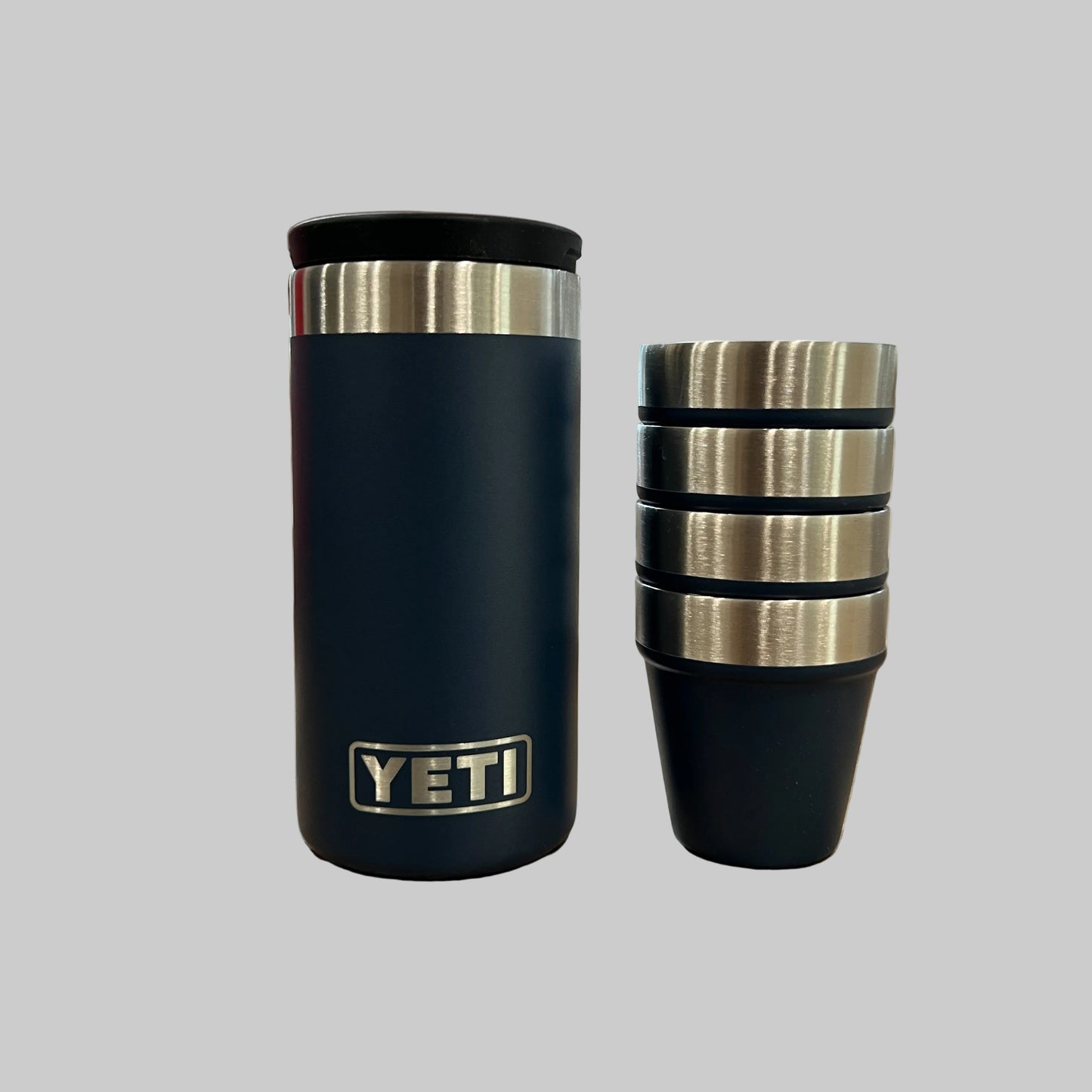 Black YETI insulated tumbler on a wooden surface with blinds in the background