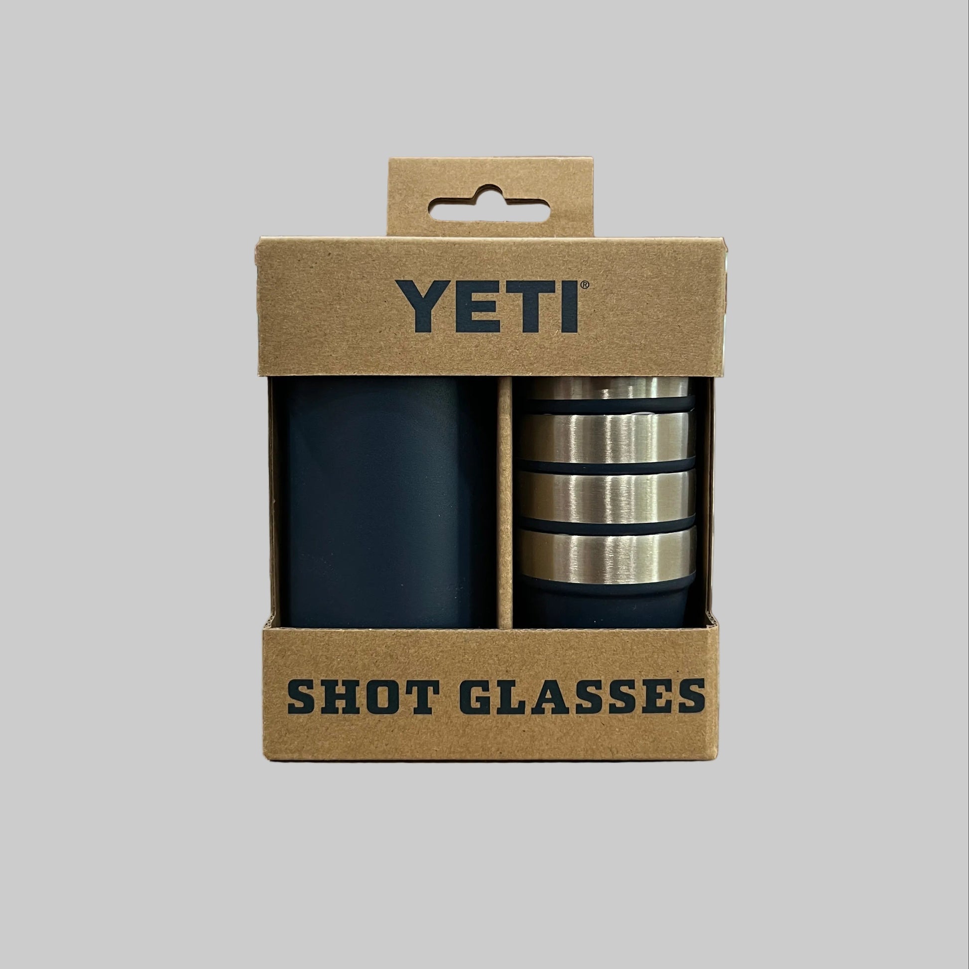 YETI shot glasses in a cardboard packaging on a wooden surface