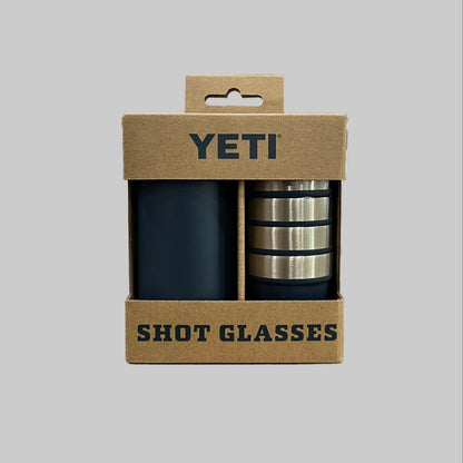 YETI shot glasses in a cardboard packaging on a wooden surface