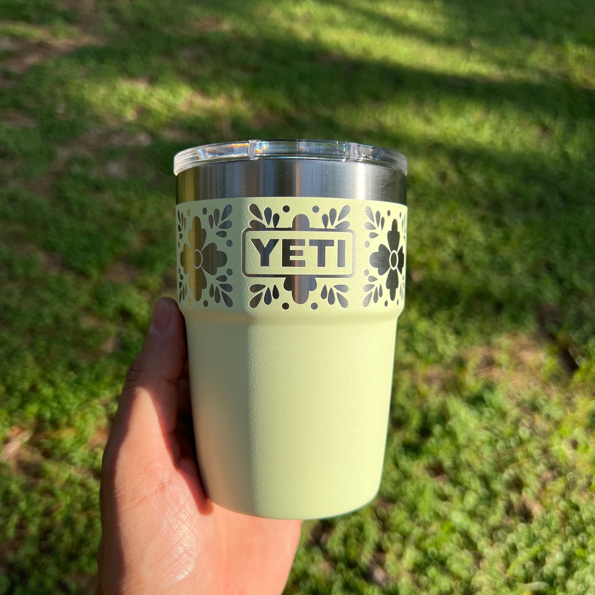 Grasshopper YETI 16oz Rambler Stackable with a floral laser engraved pattern outside in a forest pinelaserworks.com
