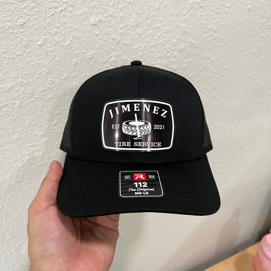 Black Richardson 112 cap with a white outlined 'JIMENEZ TIRE SERVICE' acrylic patch