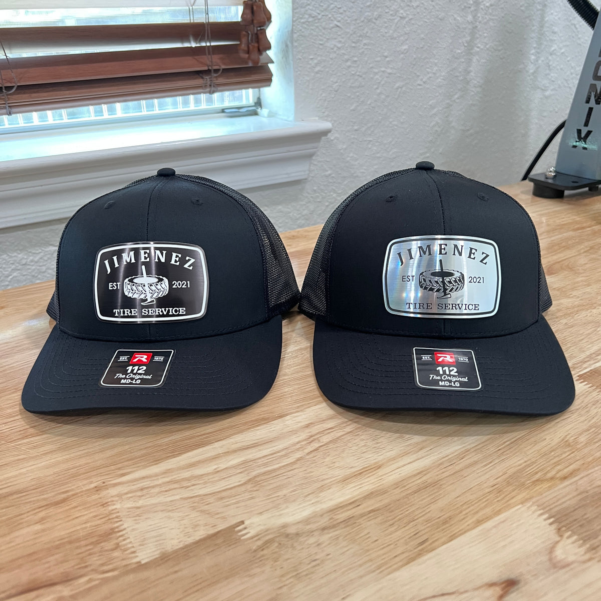Two black Richardson 112 caps with silver and white 'Jimenez' acrylic patches