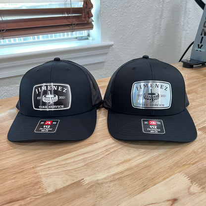 Two black Richardson 112 caps with silver and white 'Jimenez' acrylic patches