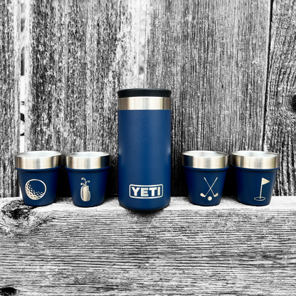 Set of blue YETI insulated cups with various designs on a wooden surface