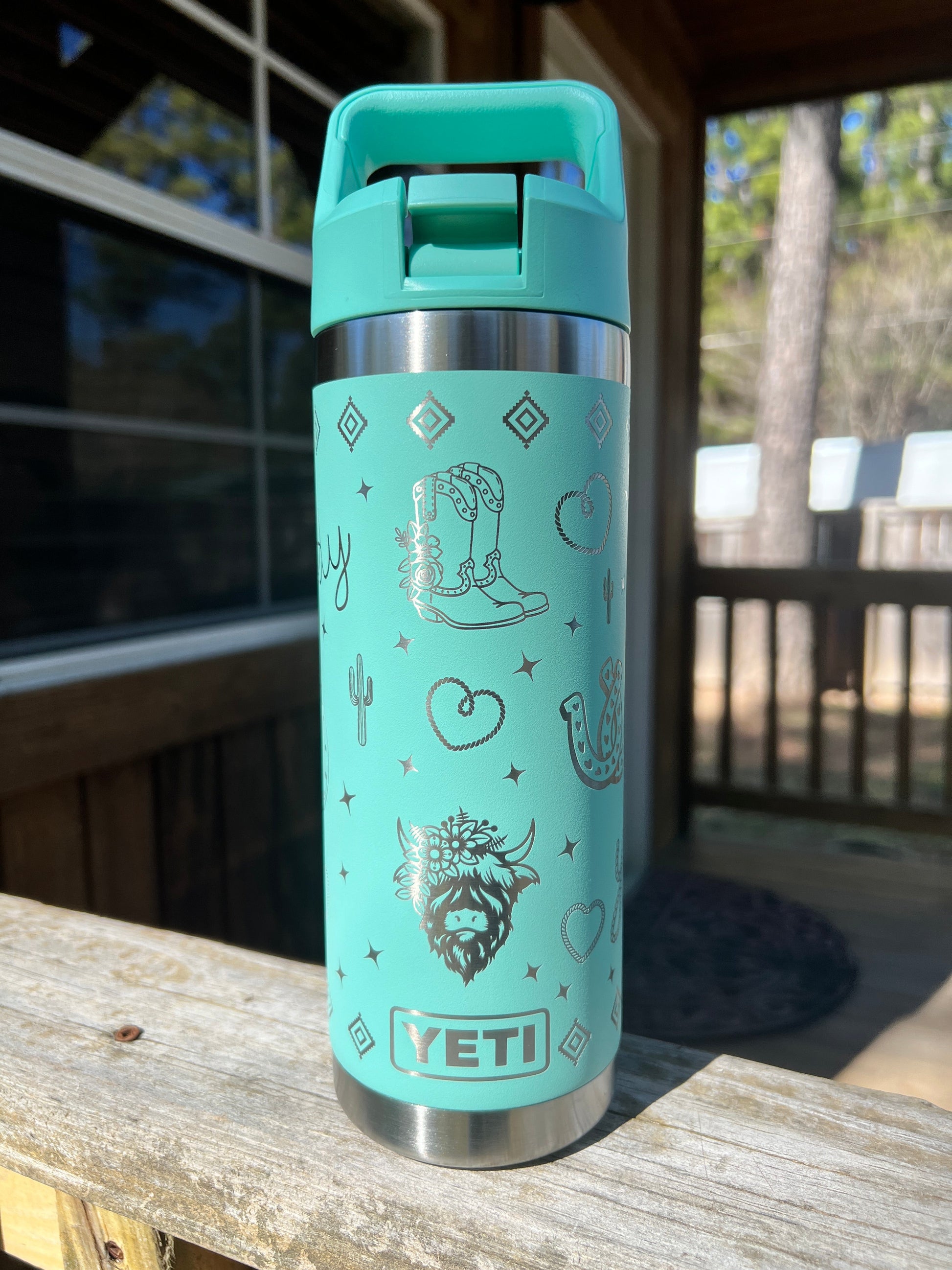 Highland Cow Yeti 18oz Water Bottle Western Theme in Seafoam Color - Pine LaserworksYeti Flip Straw Cap 18oz Rambler Water Bottle in Seafoam color Western theme with cactus rope heart highland cow cowboy boots and sparkle shapes all around beautiful shine and finish. full 360 engrave.