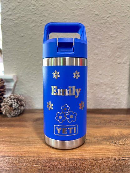 Personalized Kids Yeti 12 oz Water Bottle 12 Design Options - Pine LaserworksUltramarine Violet YETI water bottle with 'Emily' and floral designs on a wooden surface.