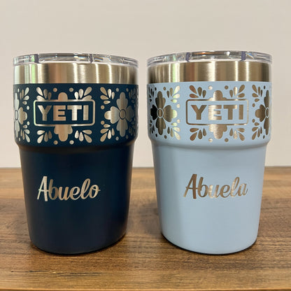 Personalized Talavera Flower Yeti 16oz Stackable Cup - Pine LaserworksTwo YETI tumblers, one navy and big sky blue, with 'Abuelo' and 'Abuela' text on a wooden surface.