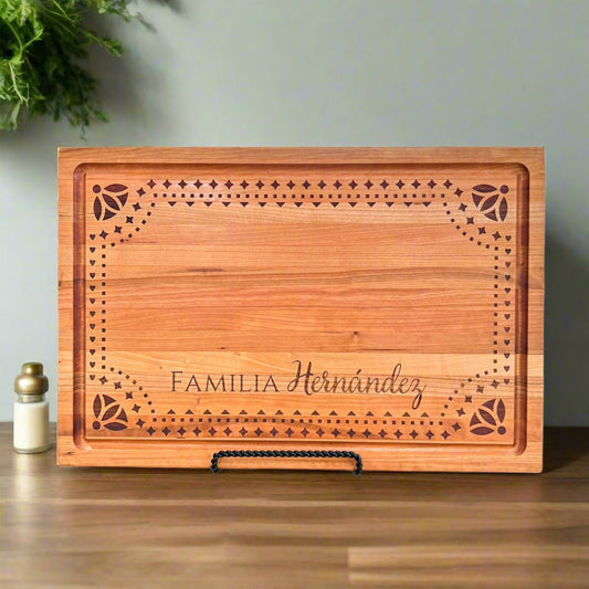 Personalized Talavera Pattern Cherry Butcher Block Cutting Board with Juice Groove - Pine LaserworksWooden cutting board with 'Familia Hernandez' engraving on a wooden surface.