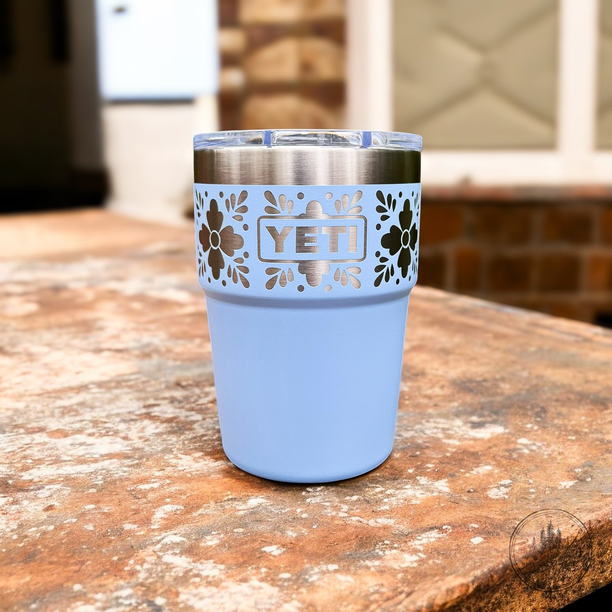 Talavera Flower Yeti 16oz Stackable Cup - Pine LaserworksBig Sky Blue YETI tumbler with floral design on a wooden surface